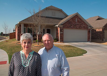 Darise and Todd Taylor stand in front of their home in The Springs at Settlers Ridge